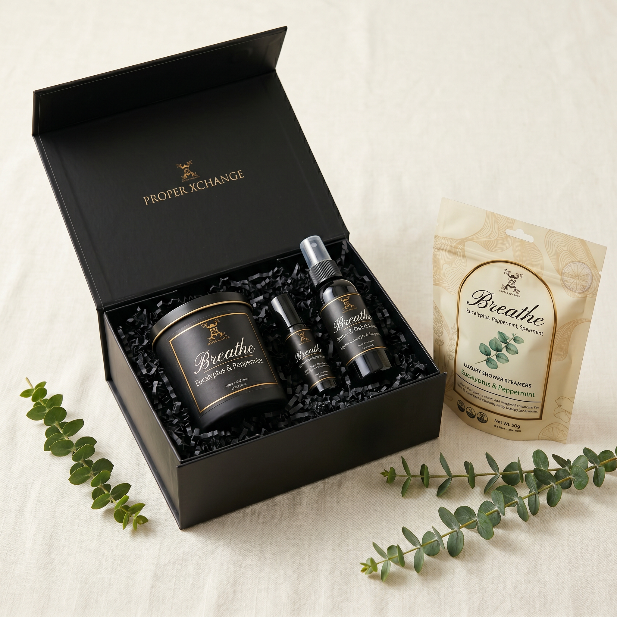 Gifting set with 'Breathe' products including a candle, diffuser, and tea, branded as Proper Exchange, on a light background.