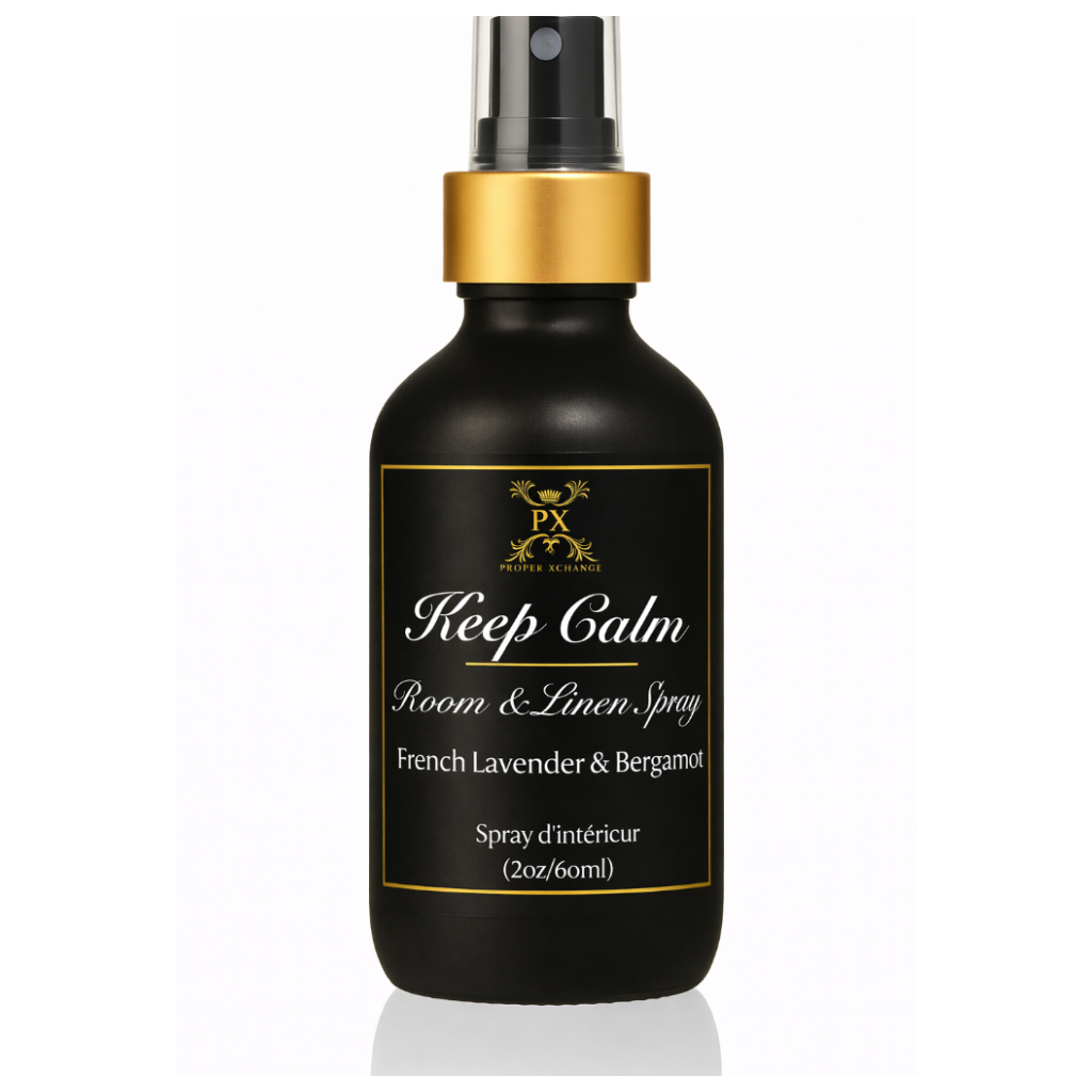 Black room & linen spray bottle with gold cap and label on a white background
