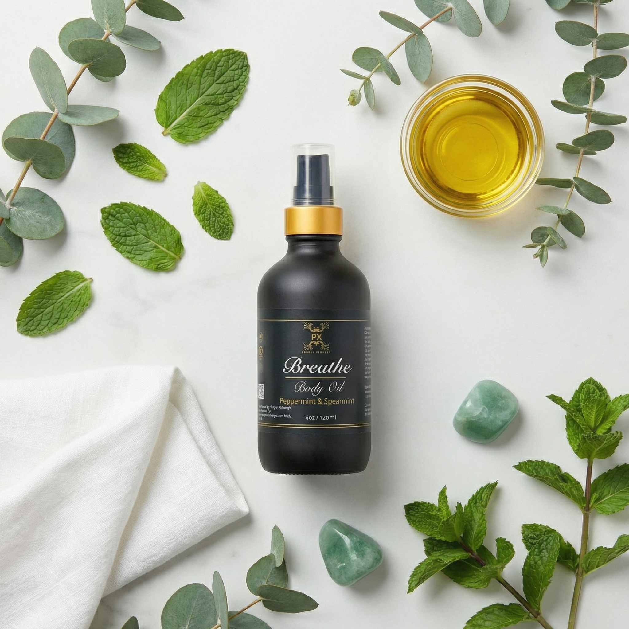 Bottle of 'Breathe' body oil with green leaves and stones on a light background