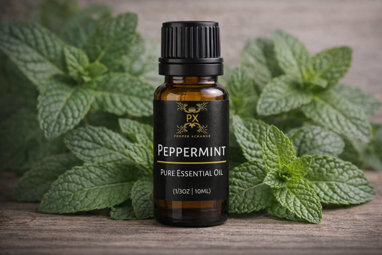 Peppermint pure essential oil bottle with fresh peppermint leaves on a wooden surface