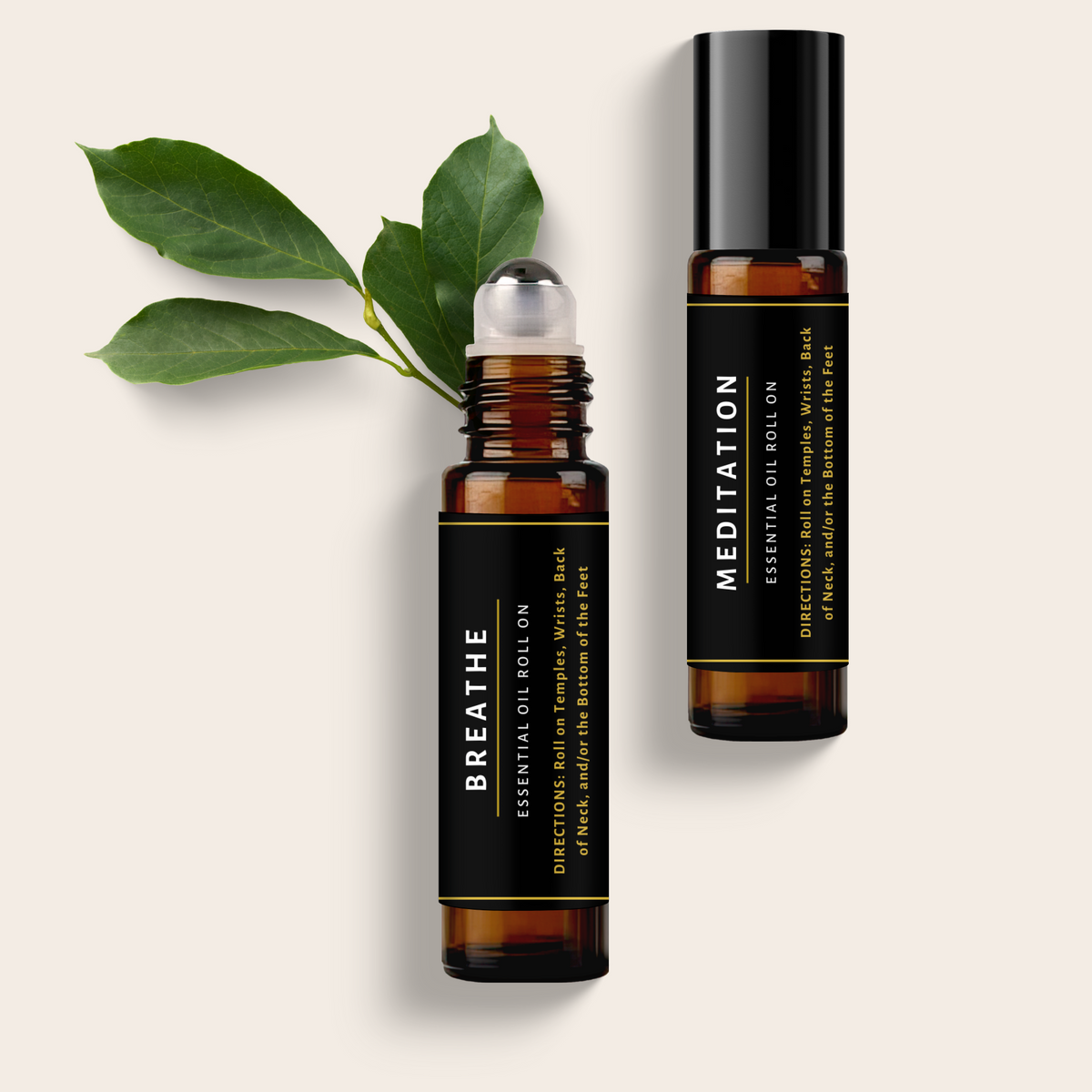 Two essential oil roller bottles labeled 'Breathe' and 'Meditation' with green leaves on a light background.