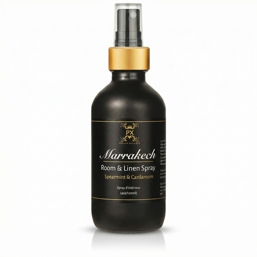 Black room & linen spray bottle with gold cap on a white background