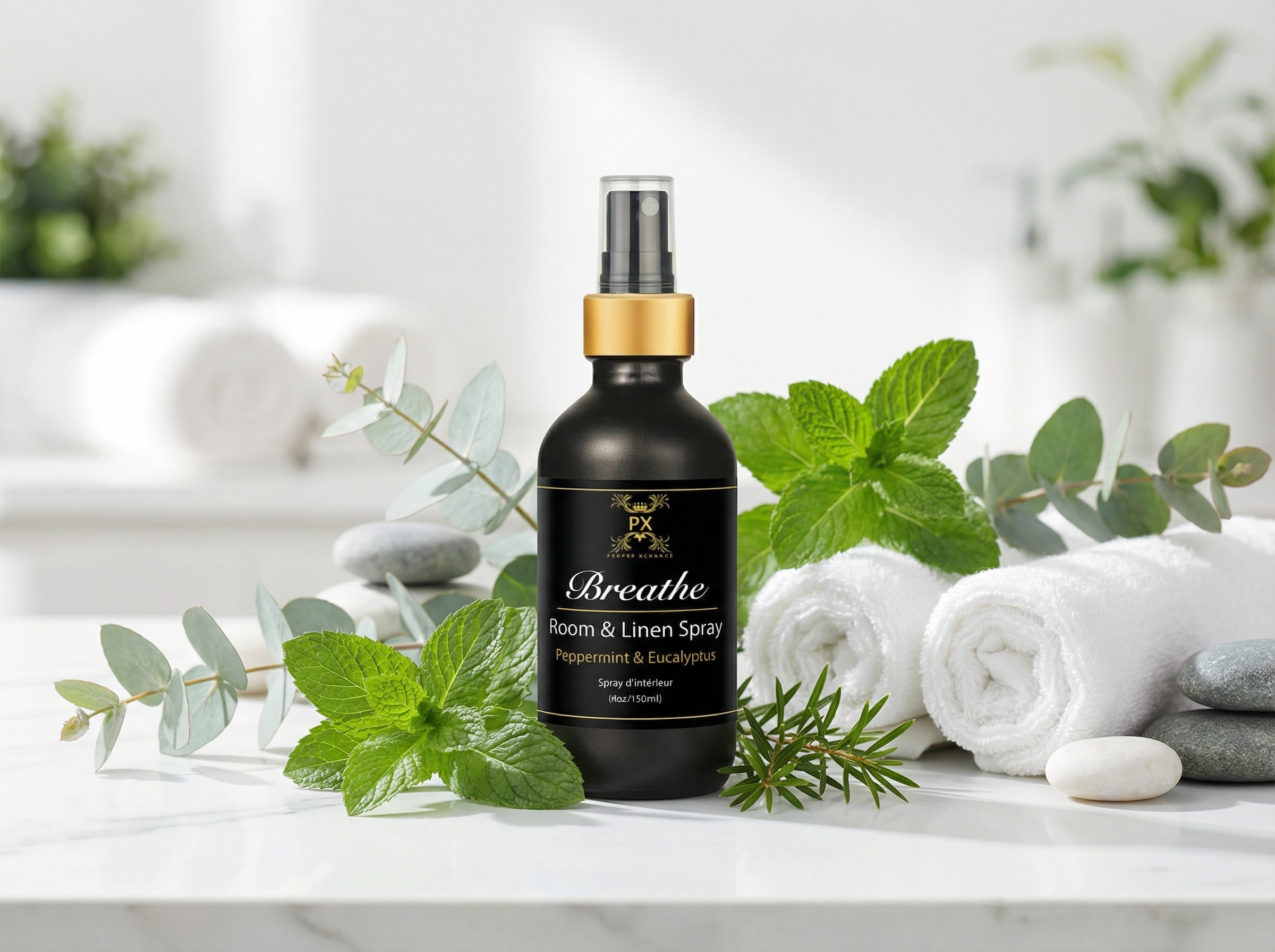 Room spray bottle with mint leaves and towels on a white surface