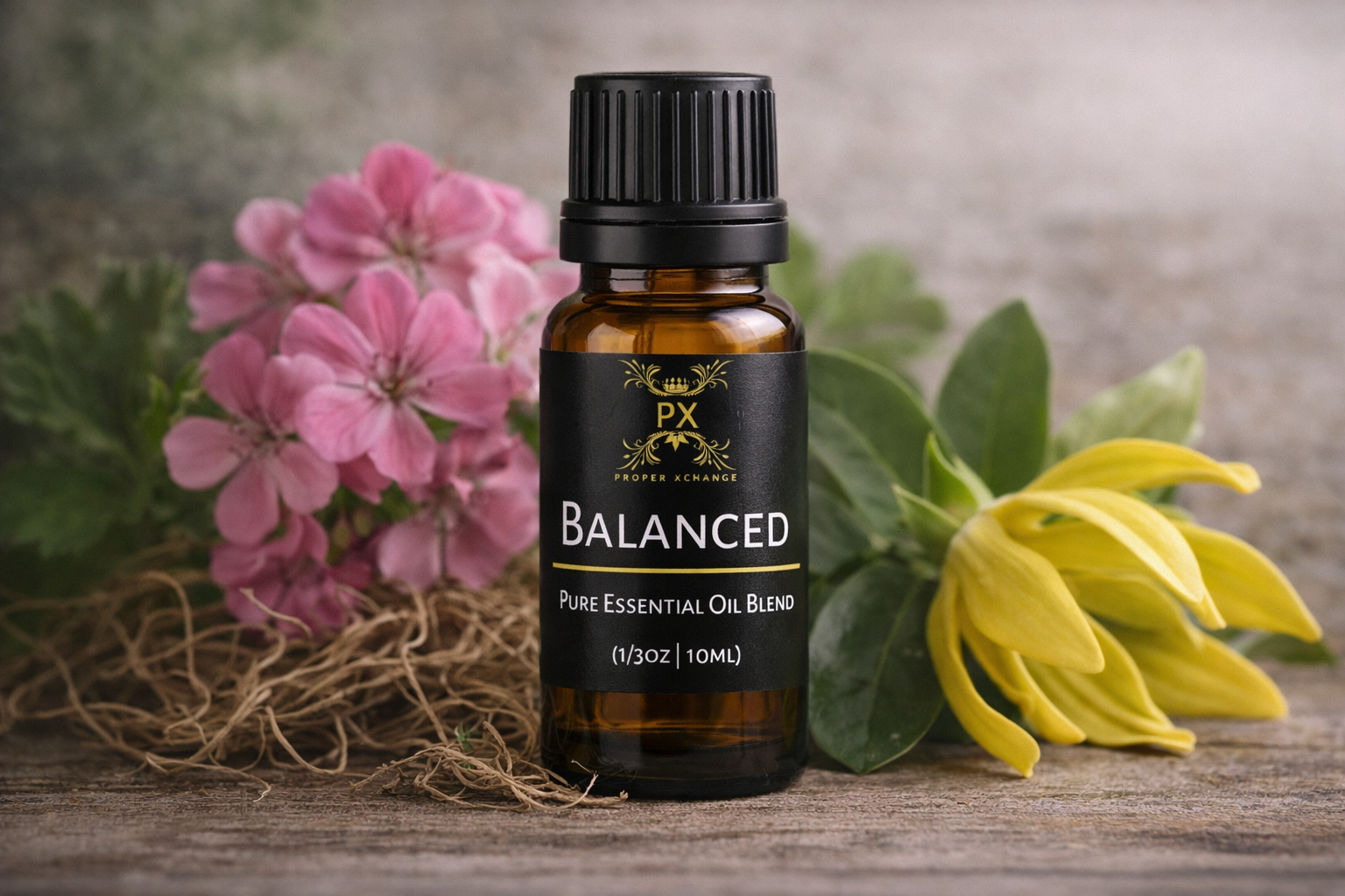 PX Balanced essential oil blend bottle with pink and yellow flowers on a wooden surface