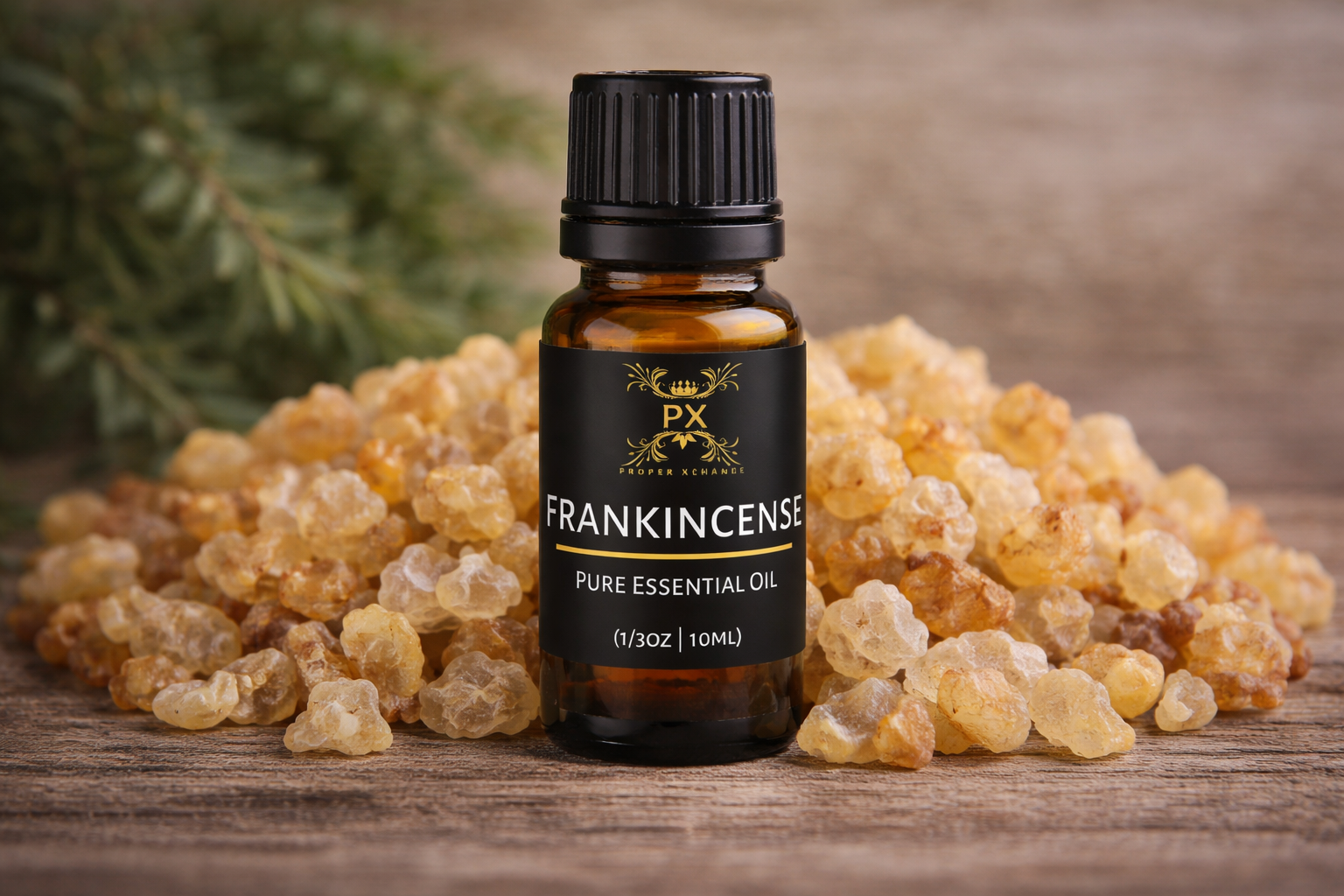 PX Frankincense pure essential oil bottle surrounded by frankincense resin on a wooden surface.