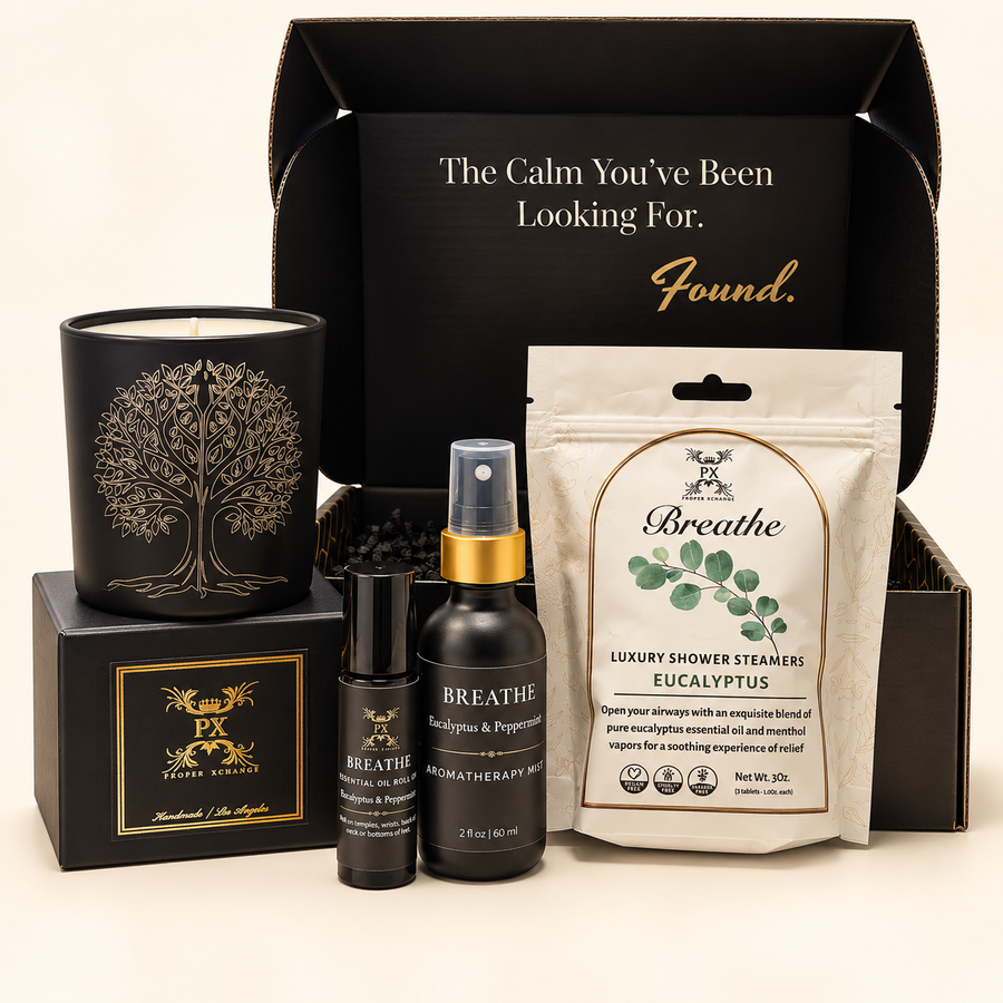 Breathe Rituals Gift Set with Tree of Life candle, roll-on, 2 oz aromatherapy mist, shower steamers, and gift packaging on an ivory background